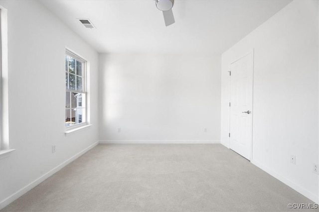 unfurnished room featuring light colored carpet and ceiling fan