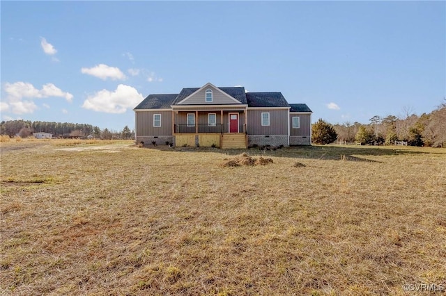 view of front of home with covered porch and a front yard