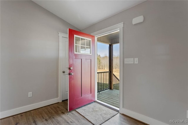 entryway featuring lofted ceiling and light wood-type flooring