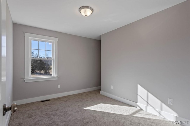 empty room featuring light colored carpet