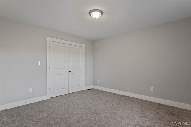 unfurnished bedroom with a closet and carpet