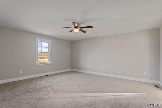 carpeted spare room with ceiling fan