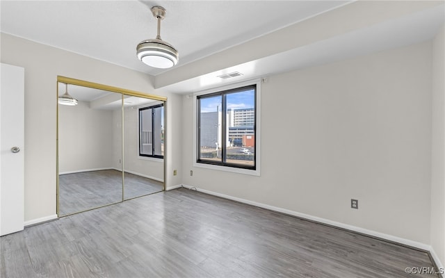 unfurnished bedroom featuring a closet and wood-type flooring