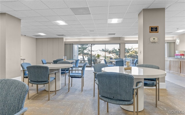 dining space featuring a drop ceiling