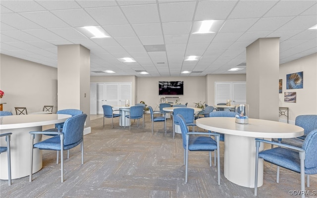 dining area with a paneled ceiling