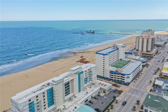 birds eye view of property with a water view and a view of the beach