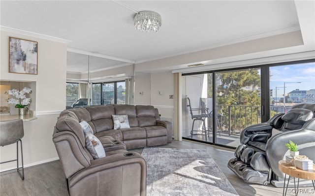 living room featuring an inviting chandelier, wood-type flooring, and plenty of natural light