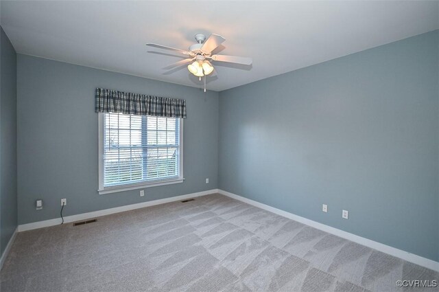 carpeted empty room with ceiling fan