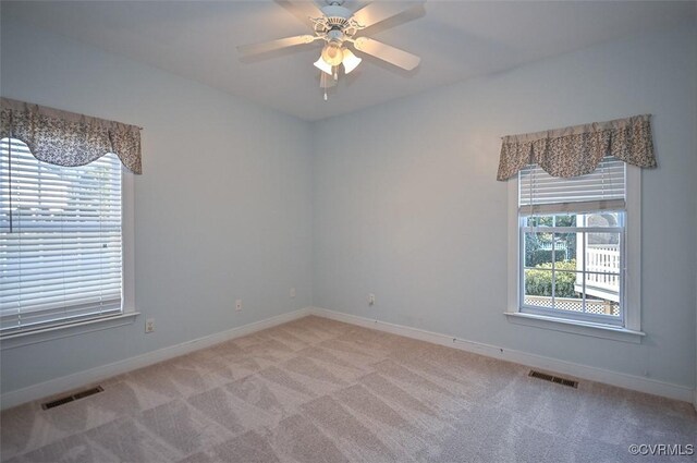 spare room with ceiling fan and carpet floors