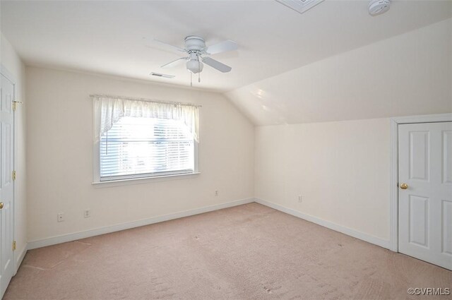 additional living space with ceiling fan, light carpet, and vaulted ceiling