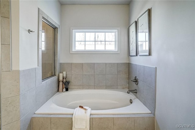 bathroom featuring a relaxing tiled tub