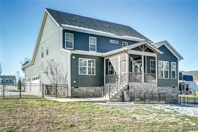 rear view of house featuring a yard and a sunroom