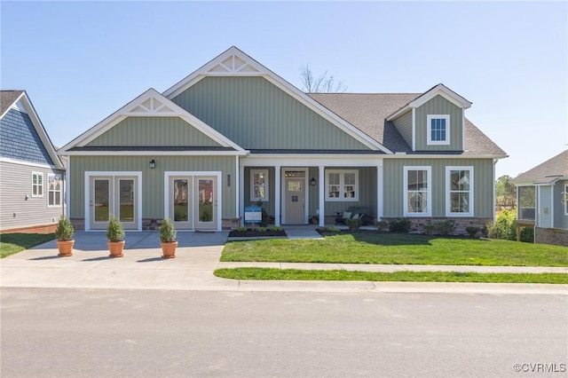 craftsman house featuring french doors and a front yard