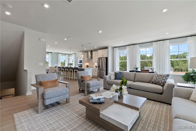 living room featuring light wood-type flooring and a wealth of natural light