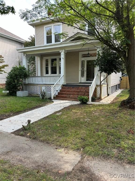 view of front of house with a porch and a front lawn