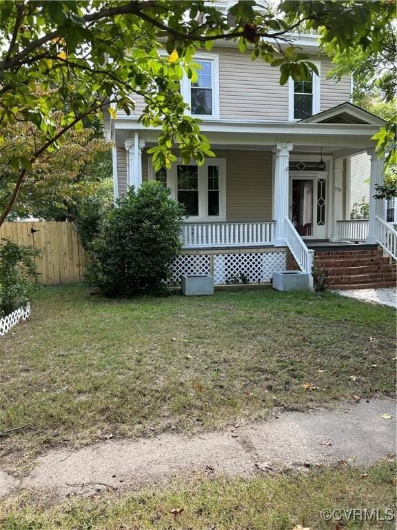 view of front of house with a porch and a front yard