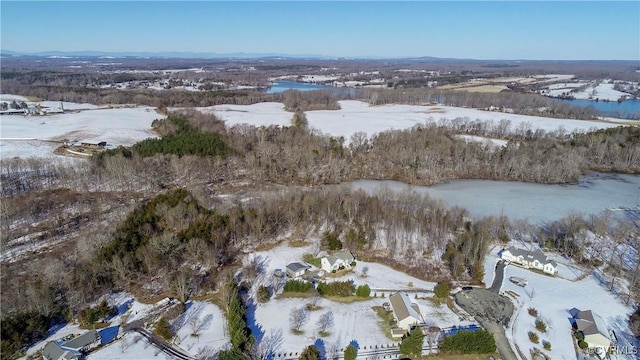 snowy aerial view featuring a water view