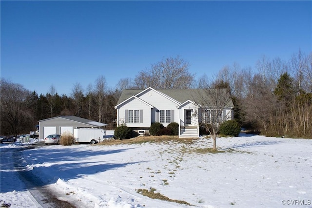 view of front of property featuring a garage and an outdoor structure