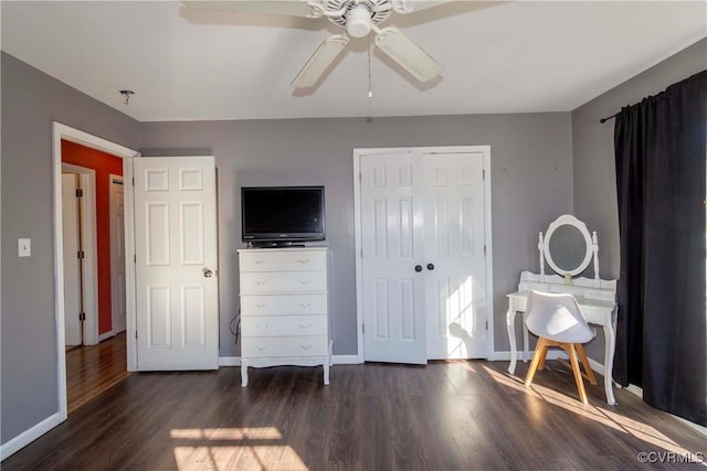 bedroom with a closet, ceiling fan, and dark hardwood / wood-style floors