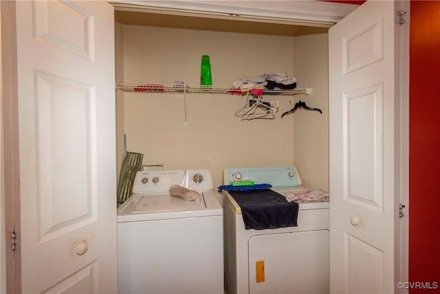 clothes washing area with separate washer and dryer