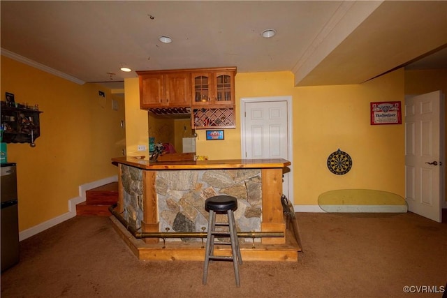 bar with carpet floors and crown molding