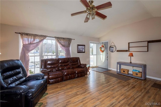 living room featuring ceiling fan, vaulted ceiling, and hardwood / wood-style flooring