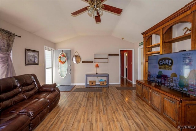 living room with lofted ceiling, ceiling fan, and light hardwood / wood-style floors