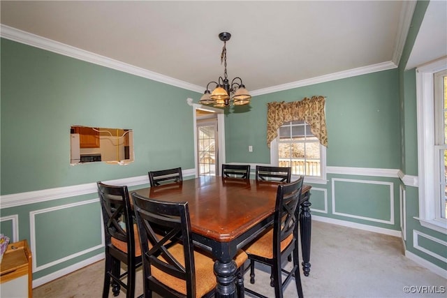 dining space with a chandelier, crown molding, and light colored carpet