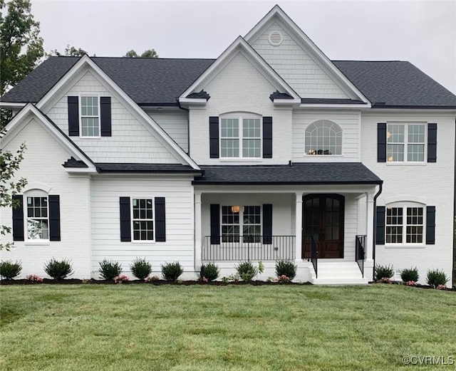 view of front of property with a front yard and covered porch