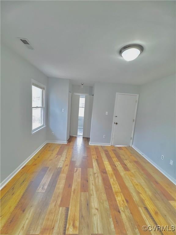 empty room with light hardwood / wood-style floors