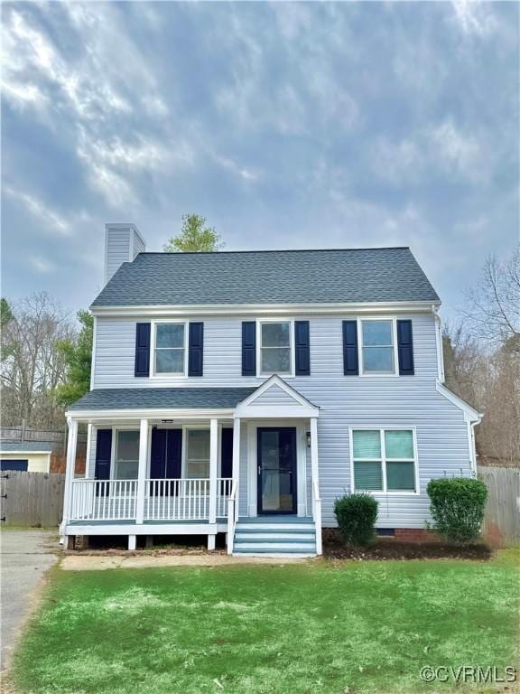 colonial home with a porch and a front lawn