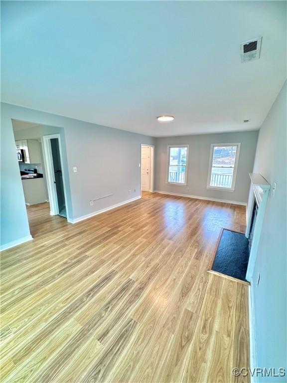 unfurnished living room with light hardwood / wood-style flooring