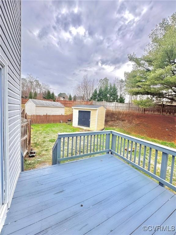 wooden terrace with a yard and a storage shed