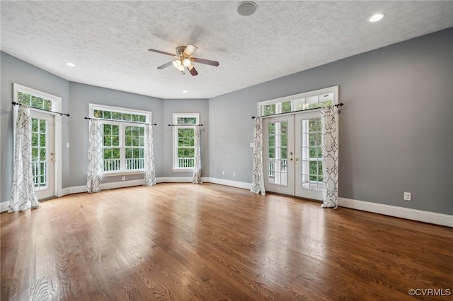 spare room featuring ceiling fan, french doors, a textured ceiling, and wood-type flooring