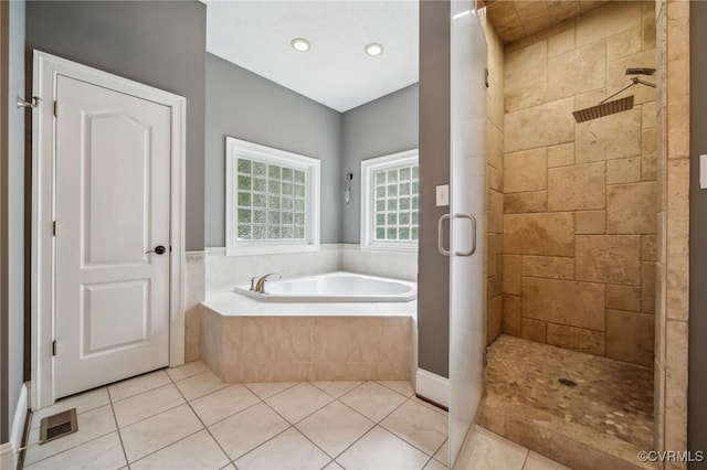 bathroom with tile patterned floors and plus walk in shower