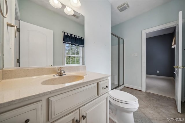 bathroom with toilet, a shower with door, vanity, and tile patterned floors