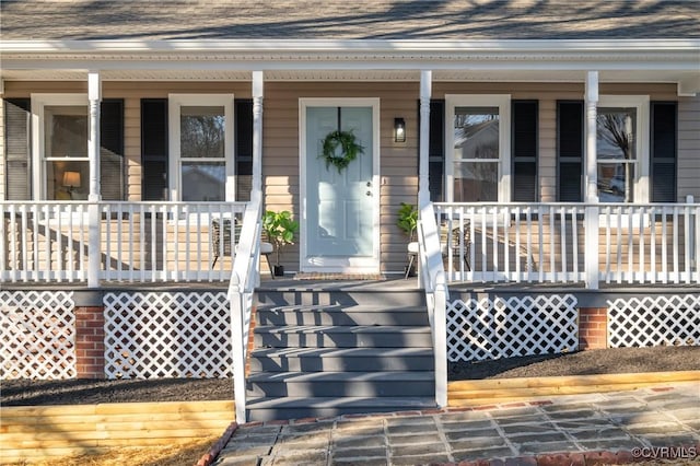 view of exterior entry with covered porch