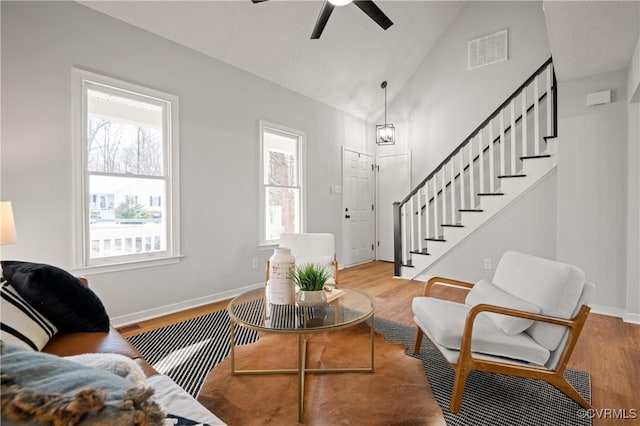 living room featuring lofted ceiling, ceiling fan, and light hardwood / wood-style floors