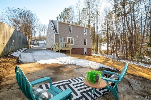 view of snow covered rear of property