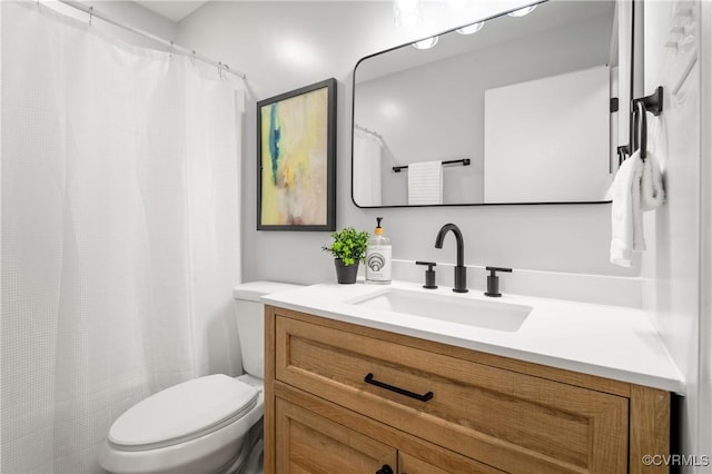 bathroom featuring toilet and vanity