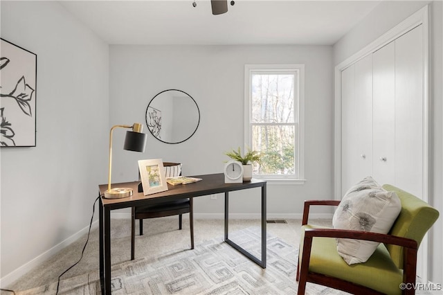 home office with a wealth of natural light and light colored carpet