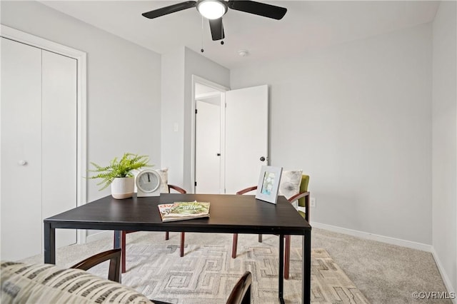 office space featuring ceiling fan and light colored carpet