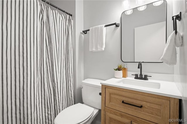 bathroom with toilet and vanity