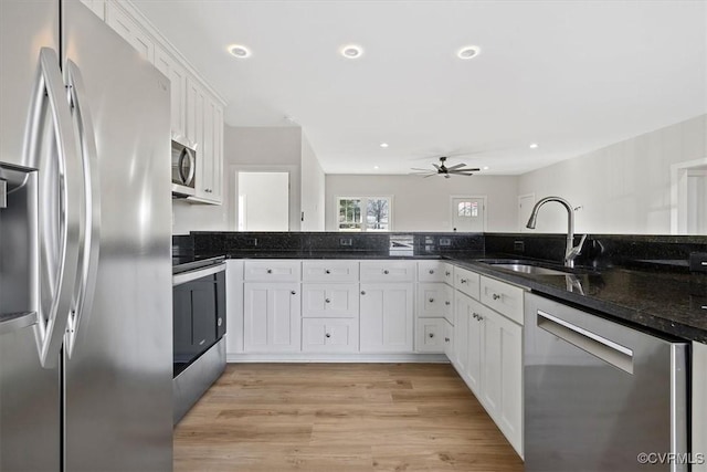 kitchen with sink, white cabinetry, and appliances with stainless steel finishes