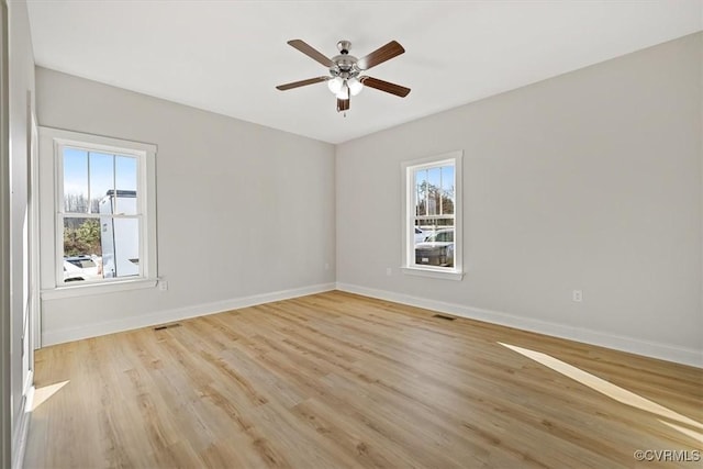 empty room featuring light wood-type flooring and ceiling fan