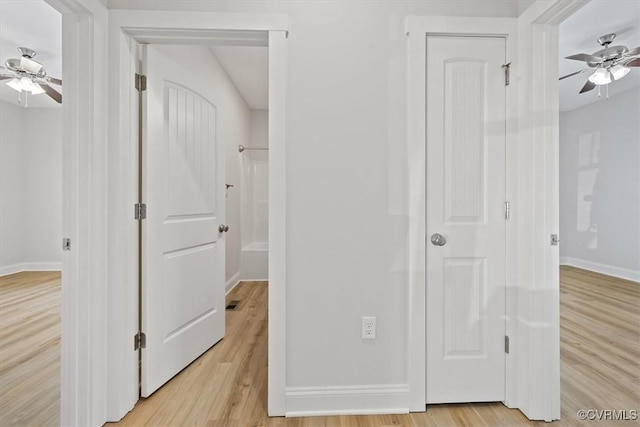 hallway with light hardwood / wood-style flooring