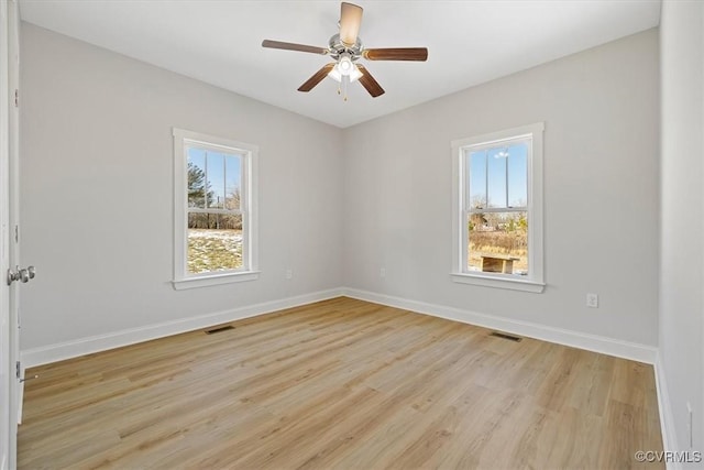 unfurnished room featuring ceiling fan, light hardwood / wood-style floors, and plenty of natural light