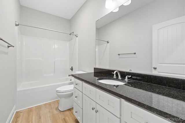 full bathroom featuring toilet, vanity, hardwood / wood-style floors, and shower / bathtub combination