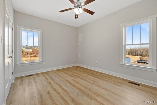 spare room with light hardwood / wood-style floors and ceiling fan