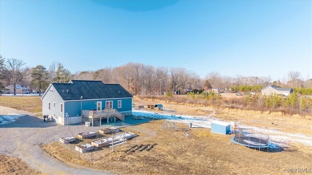 rear view of property featuring a wooden deck